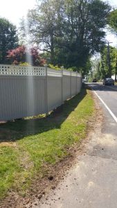 Photo of white privacy fence along the street from May 2018